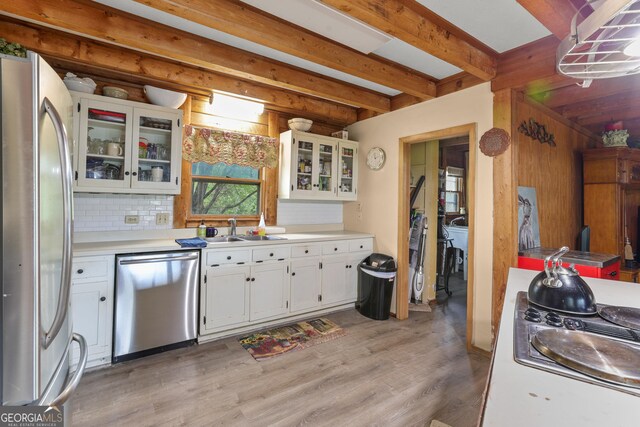 223 Arthur Rd, Zebulon, GA 30295 - kitchen featuring appliances with stainless steel finishes, light wood-style floors, white cabinetry, a sink, and beam ceiling