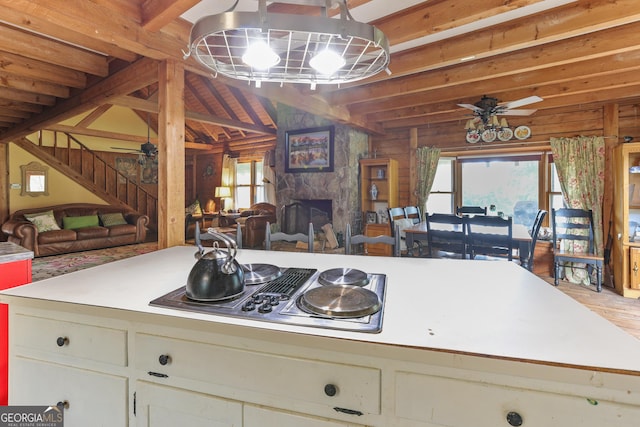 223 Arthur Rd, Zebulon, GA 30295 - kitchen with open floor plan, a ceiling fan, light countertops, a stone fireplace, and stainless steel electric stovetop