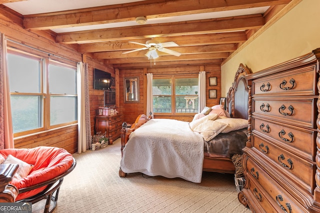 223 Arthur Rd, Zebulon, GA 30295 - bedroom featuring wooden walls, beam ceiling, light colored carpet, and ceiling fan