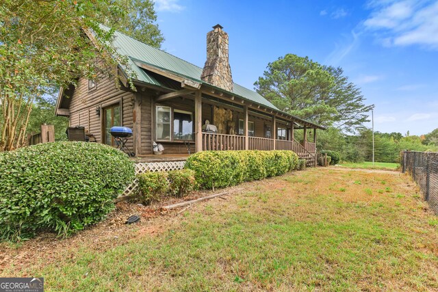 223 Arthur Rd, Zebulon, GA 30295 - view of side of home featuring a chimney and metal roof
