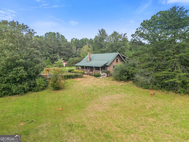 223 Arthur Rd, Zebulon, GA 30295 - view of green lawn featuring covered porch and a forest view