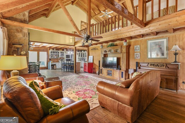 223 Arthur Rd, Zebulon, GA 30295 - living area with ceiling fan, high vaulted ceiling, wood-type flooring, beamed ceiling, and wooden walls