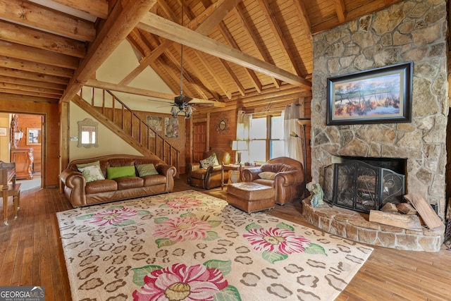 223 Arthur Rd, Zebulon, GA 30295 - living room with stairway, a stone fireplace, wooden ceiling with exposed beams, hardwood / wood-style flooring, and ceiling fan