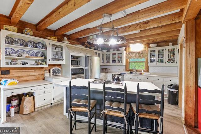 223 Arthur Rd, Zebulon, GA 30295 - kitchen featuring appliances with stainless steel finishes, a sink, open shelves, light countertops, and light wood-style floors