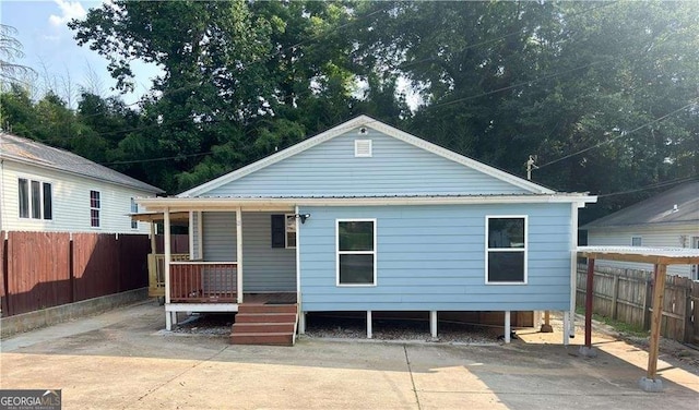 13 Hilltop St, Gainesville, GA 30501 - rear view of property featuring a porch, a fenced backyard, and metal roof