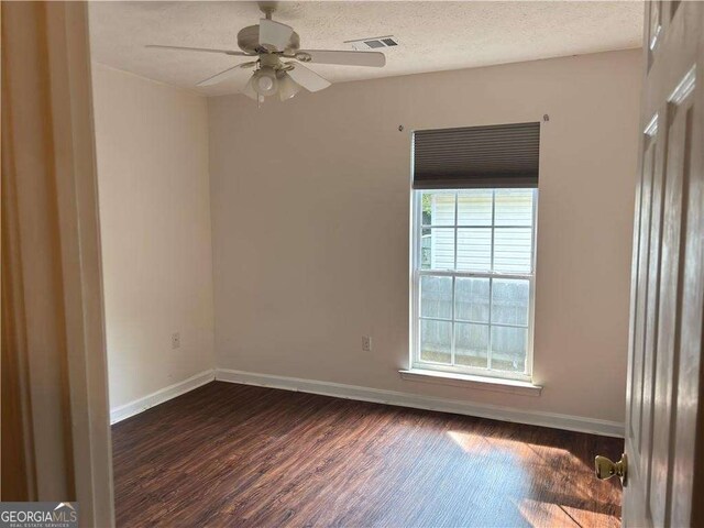 13 Hilltop St, Gainesville, GA 30501 - empty room with dark wood-style floors, ceiling fan, and baseboards