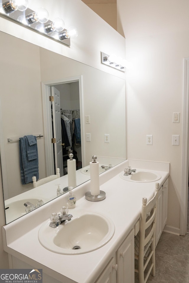 2407 Cove Lake Way, Lithonia, GA 30058 - bathroom featuring double vanity and a spacious closet