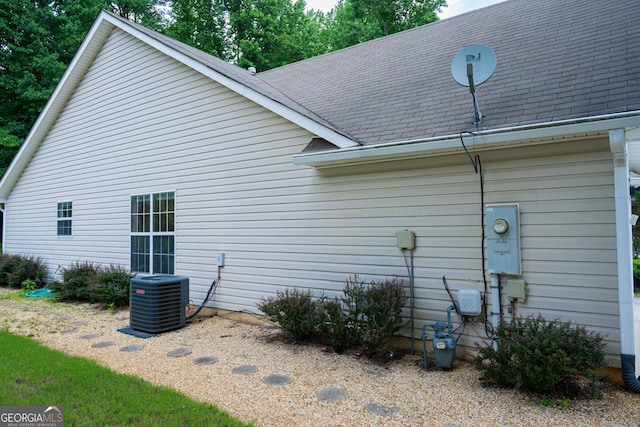 2407 Cove Lake Way, Lithonia, GA 30058 - view of side of property with a central air condition unit and roof with shingles