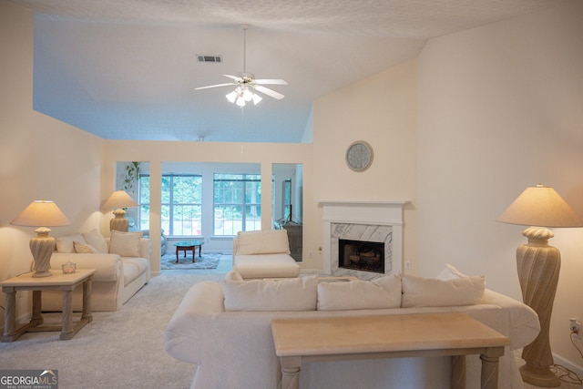 2407 Cove Lake Way, Lithonia, GA 30058 - living area featuring light carpet, ceiling fan, high vaulted ceiling, and a high end fireplace