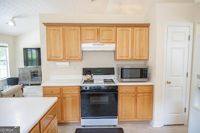 2407 Cove Lake Way, Lithonia, GA 30058 - kitchen featuring stainless steel microwave, gas range, under cabinet range hood, vaulted ceiling, and light countertops