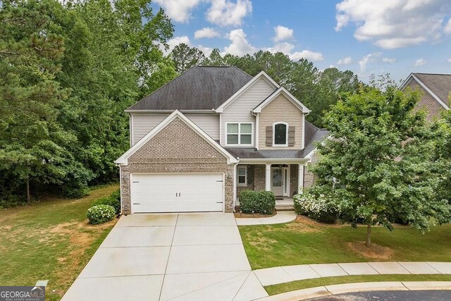 1015 Turtle Pond Dr, Watkinsville, GA 30677 - craftsman-style home featuring a front yard, driveway, a porch, and brick siding