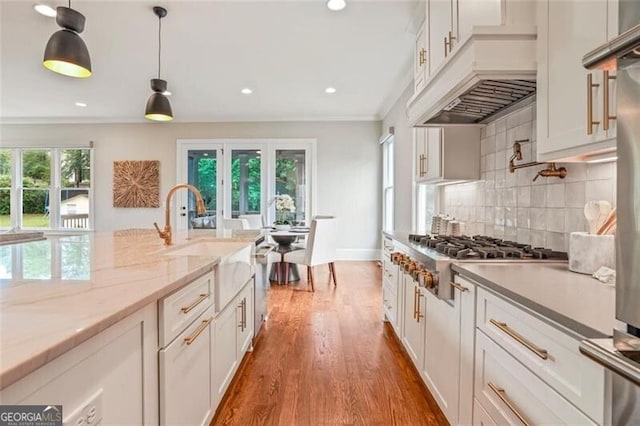 2493 Oostanaula Dr, Brookhaven, GA 30319 - kitchen featuring crown molding, backsplash, dark wood-type flooring, appliances with stainless steel finishes, and a sink