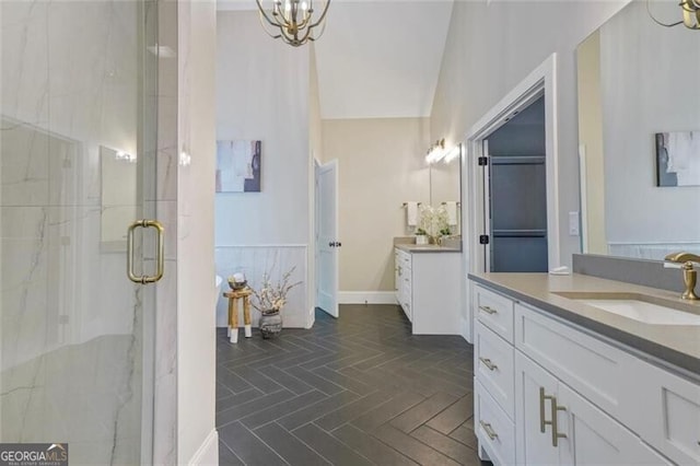 2493 Oostanaula Dr, Brookhaven, GA 30319 - bathroom with a marble finish shower, two vanities, and a chandelier