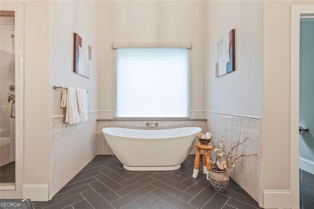 2493 Oostanaula Dr, Brookhaven, GA 30319 - full bath featuring a stall shower, wainscoting, a freestanding bath, and tile walls