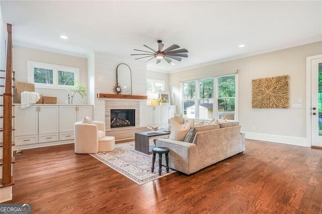 2493 Oostanaula Dr, Brookhaven, GA 30319 - living room featuring a ceiling fan, a fireplace with raised hearth, wood finished floors, baseboards, and recessed lighting