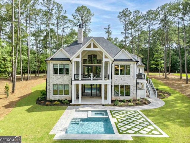 5050 Browns Ford Rd, Greensboro, GA 30642 - back of property with a balcony, a lawn, a chimney, and brick siding