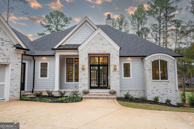 5050 Browns Ford Rd, Greensboro, GA 30642 - view of front facade featuring a chimney, a shingled roof, and brick siding
