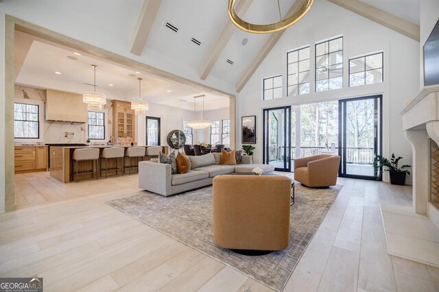 5050 Browns Ford Rd, Greensboro, GA 30642 - living area with high vaulted ceiling, beamed ceiling, a fireplace, light wood finished floors, and recessed lighting