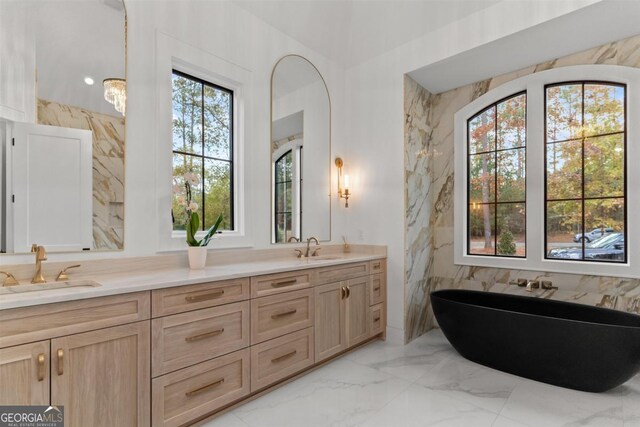 5050 Browns Ford Rd, Greensboro, GA 30642 - full bathroom featuring double vanity, a soaking tub, and marble tiled floors