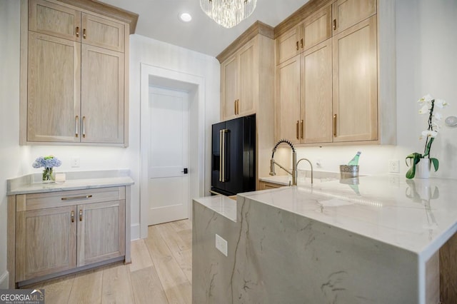 5050 Browns Ford Rd, Greensboro, GA 30642 - kitchen with freestanding refrigerator, light brown cabinetry, light stone counters, light wood-style flooring, and a chandelier