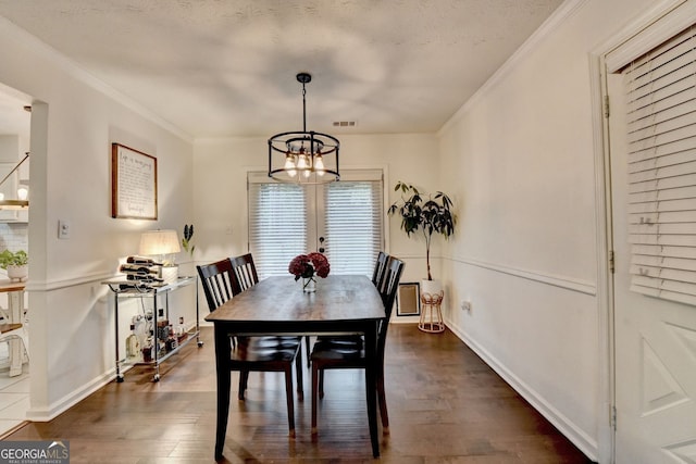 3694 Jay Bird Aly, Peachtree Corners, GA 30092 - dining room featuring a chandelier, dark wood finished floors, crown molding, baseboards, and a textured ceiling
