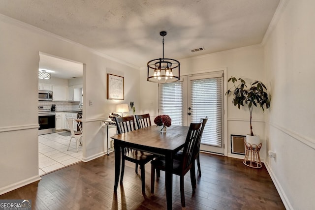 3694 Jay Bird Aly, Peachtree Corners, GA 30092 - dining room with ornamental molding, wood-type flooring, a chandelier, and baseboards