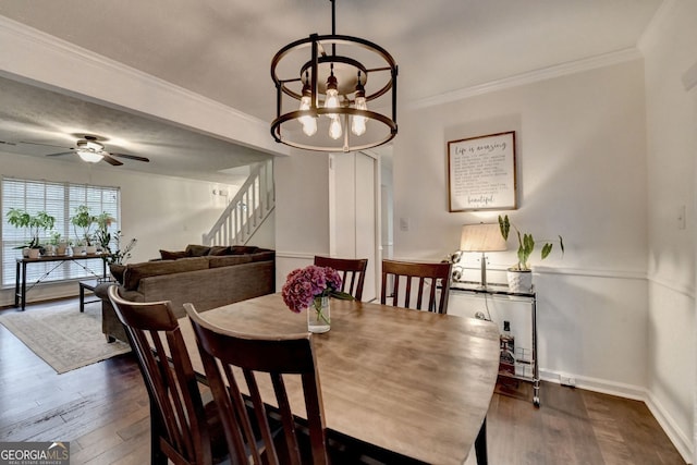 3694 Jay Bird Aly, Peachtree Corners, GA 30092 - dining space with dark wood-style floors, stairway, a chandelier, baseboards, and crown molding