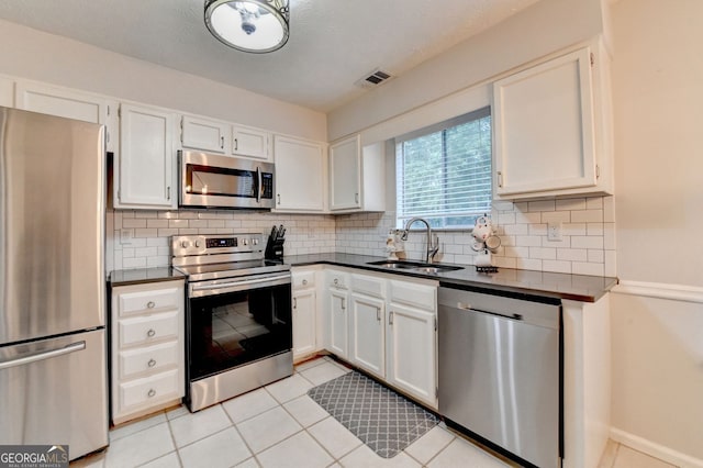 3694 Jay Bird Aly, Peachtree Corners, GA 30092 - kitchen featuring stainless steel appliances, a sink, dark countertops, and tasteful backsplash