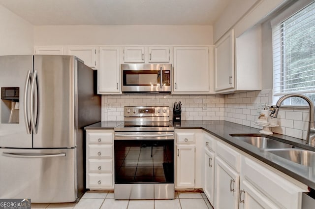 3694 Jay Bird Aly, Peachtree Corners, GA 30092 - kitchen with appliances with stainless steel finishes, a sink, dark countertops, and tasteful backsplash