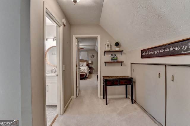 3694 Jay Bird Aly, Peachtree Corners, GA 30092 - corridor with vaulted ceiling, a textured ceiling, light colored carpet, baseboards, and a sink