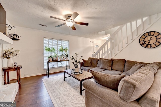 3694 Jay Bird Aly, Peachtree Corners, GA 30092 - living room featuring dark wood-style floors, stairs, ceiling fan, a textured ceiling, and baseboards