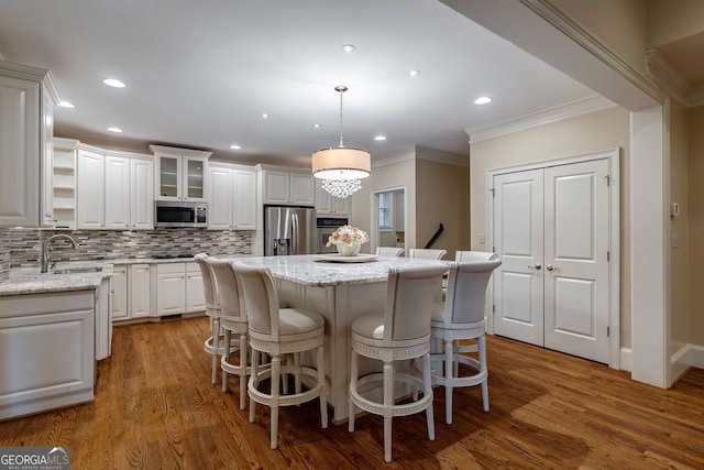 1984 Mendenhall Cir, Atlanta, GA 30341 - kitchen with stainless steel appliances, crown molding, white cabinets, a kitchen island, and tasteful backsplash