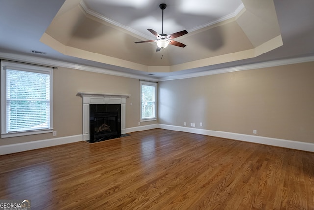1984 Mendenhall Cir, Atlanta, GA 30341 - unfurnished living room featuring a raised ceiling, a ceiling fan, a tile fireplace, wood finished floors, and crown molding