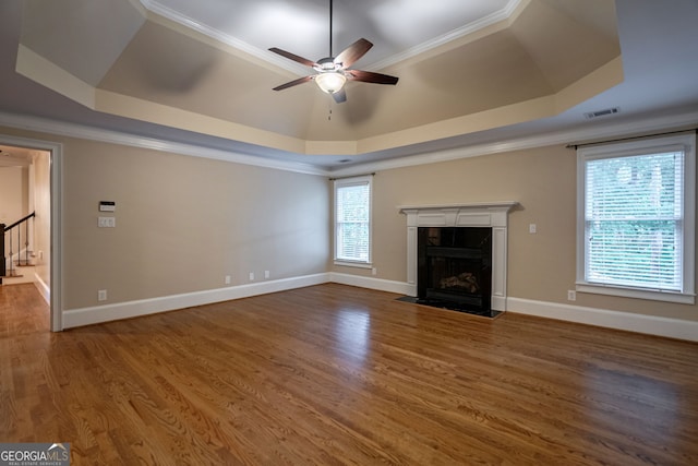 1984 Mendenhall Cir, Atlanta, GA 30341 - unfurnished living room featuring a raised ceiling, ceiling fan, a high end fireplace, ornamental molding, and wood finished floors