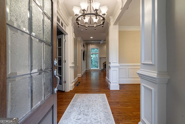 1984 Mendenhall Cir, Atlanta, GA 30341 - entrance foyer with crown molding, dark wood-type flooring, a chandelier, decorative columns, and a decorative wall