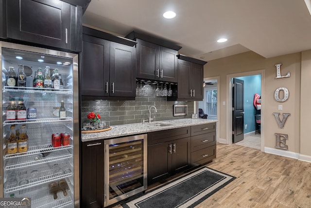 1984 Mendenhall Cir, Atlanta, GA 30341 - kitchen with beverage cooler, light wood finished floors, tasteful backsplash, light stone countertops, and recessed lighting