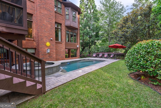 1984 Mendenhall Cir, Atlanta, GA 30341 - view of swimming pool with a yard, a pool with connected hot tub, and a patio