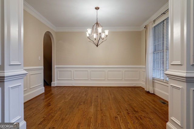 1984 Mendenhall Cir, Atlanta, GA 30341 - unfurnished dining area with ornamental molding, arched walkways, wood finished floors, a chandelier, and a wainscoted wall