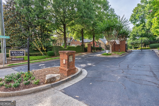 1984 Mendenhall Cir, Atlanta, GA 30341 - view of asphalt street featuring a gate, a gated entry, and curbs