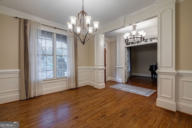 1984 Mendenhall Cir, Atlanta, GA 30341 - unfurnished dining area with a chandelier, dark wood-style floors, healthy amount of natural light, a decorative wall, and wainscoting
