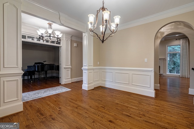 1984 Mendenhall Cir, Atlanta, GA 30341 - unfurnished dining area with a chandelier, wood finished floors, arched walkways, ornamental molding, and a wainscoted wall