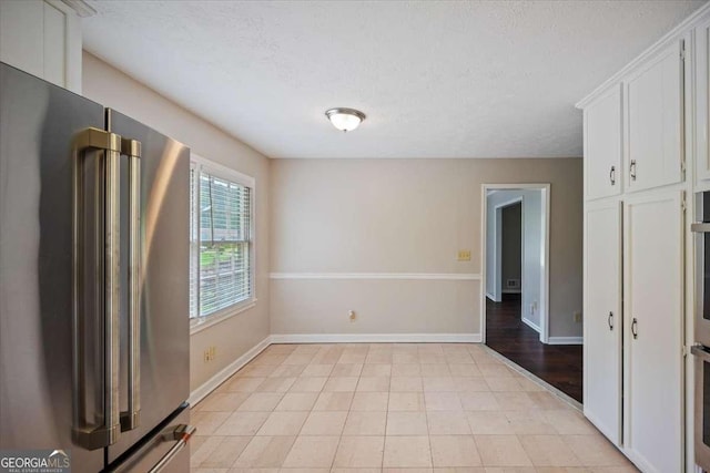 3802 Birchbriar Ct, Decatur, GA 30034 - unfurnished dining area featuring baseboards and a textured ceiling