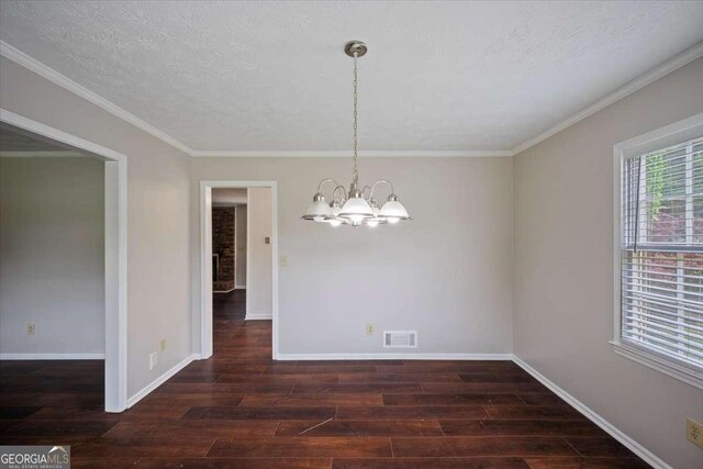 3802 Birchbriar Ct, Decatur, GA 30034 - unfurnished dining area with a chandelier, wood finished floors, baseboards, and crown molding