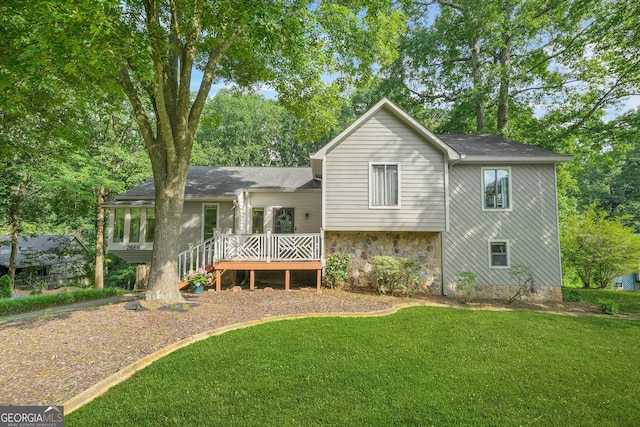 2666 Peachtree Walk, Duluth, GA 30096 - back of property with a deck, a yard, roof with shingles, and stone siding