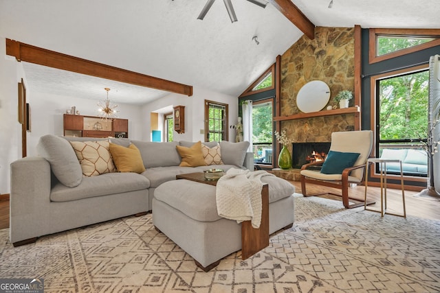 2666 Peachtree Walk, Duluth, GA 30096 - living area featuring light wood-style floors, a chandelier, a stone fireplace, ceiling fan, and a textured ceiling