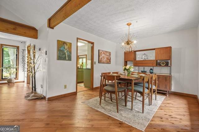 2666 Peachtree Walk, Duluth, GA 30096 - dining space featuring a chandelier, light wood finished floors, and a textured ceiling