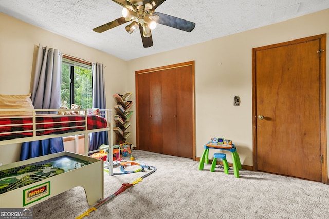 2666 Peachtree Walk, Duluth, GA 30096 - bedroom featuring carpet floors, a closet, a textured ceiling, and a ceiling fan