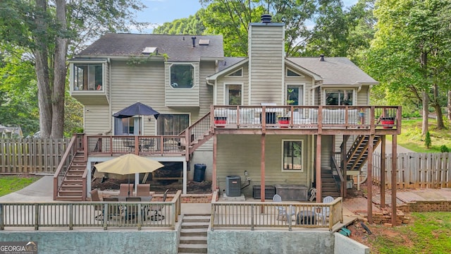2666 Peachtree Walk, Duluth, GA 30096 - back of house featuring stairway, a wooden deck, a chimney, and a fenced backyard
