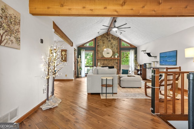 2666 Peachtree Walk, Duluth, GA 30096 - living area featuring a ceiling fan, beamed ceiling, high vaulted ceiling, hardwood / wood-style flooring, and a stone fireplace