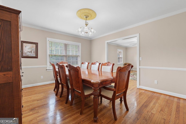 207 Saddle Mountain Rd SE, Rome, GA 30161 - dining space with healthy amount of natural light, a chandelier, light wood finished floors, ornamental molding, and baseboards